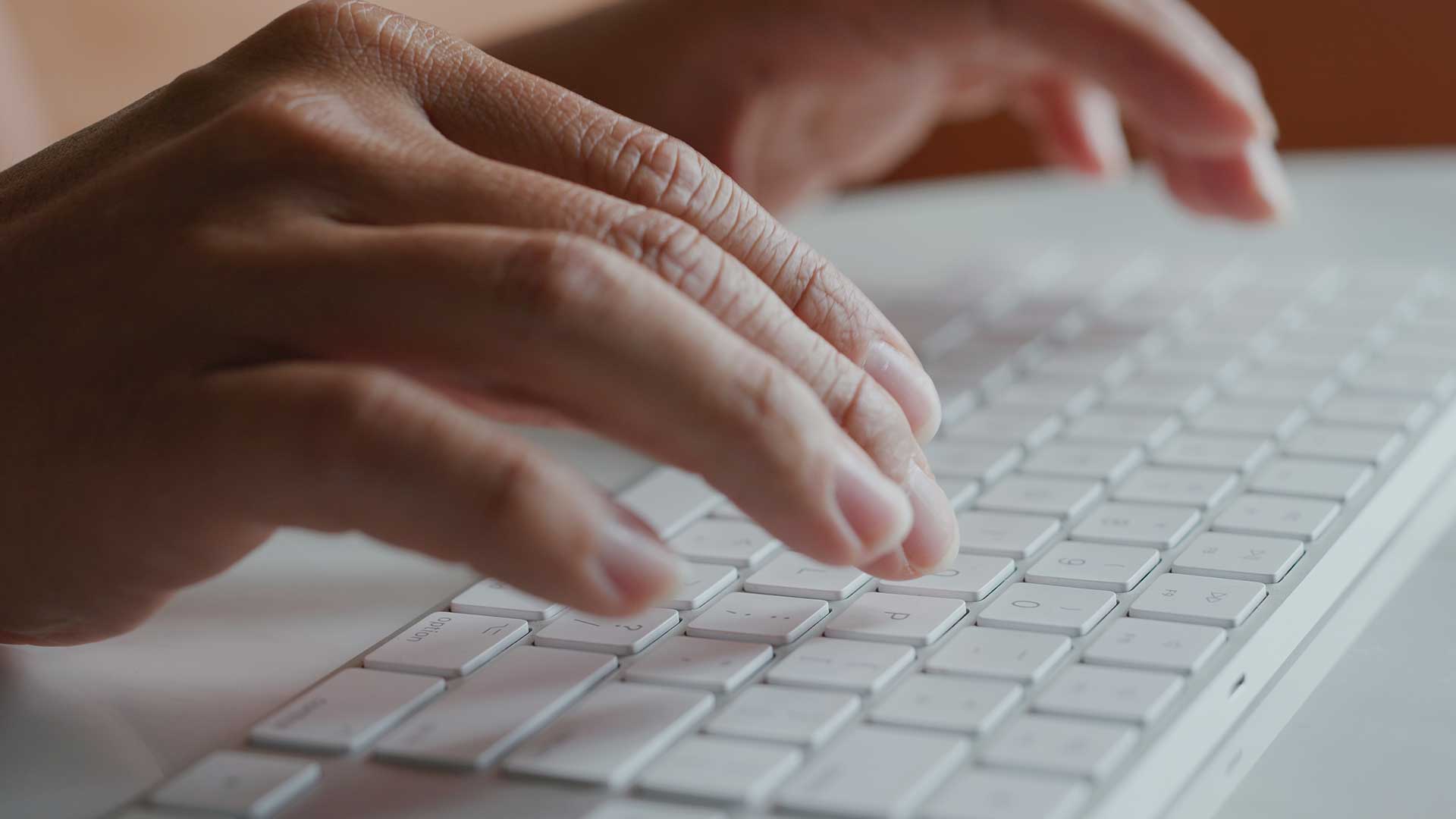 Blogging man using keyboard to